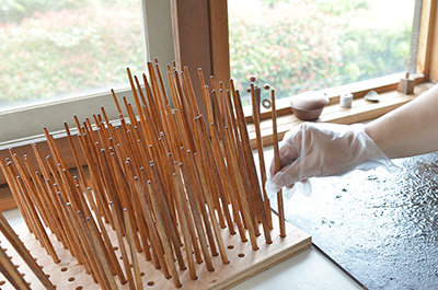 A special rack used to hold the drying chopsticks, each are worked on separately.