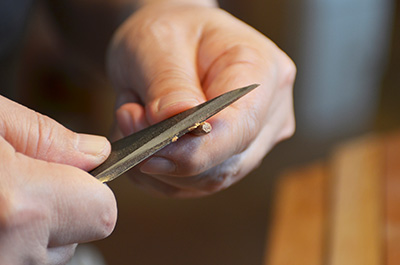 Eiji trimming the chopsticks at his studio. He pays particular attention to where the chopsticks narrow in at the tip.