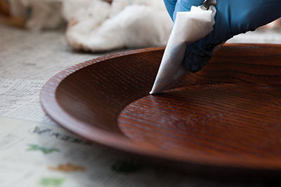 Touching up the surface of a lacquer dish with Minako Fujii of Fujii Workshop.