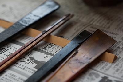A selection of brushes and tools used to apply the lacquer to the vessels.