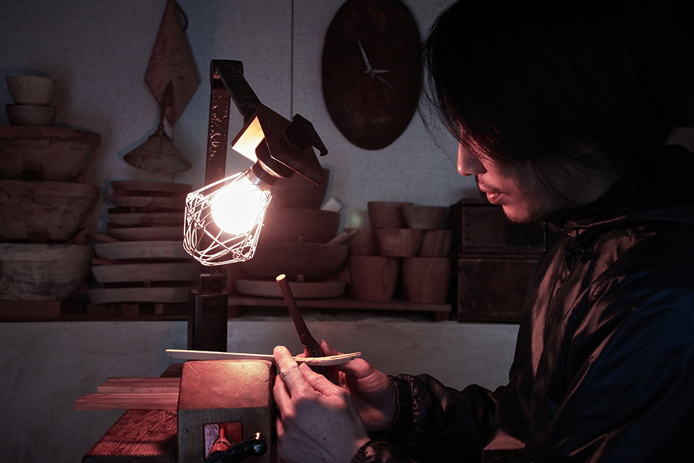 Hiroyuki Sugawara in his workshop, shaping a fork in to the desired shape.