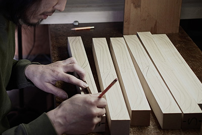 Next he draws out the template for the spoons, making sure that he makes the most out of the wood.
