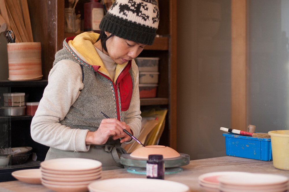 Using wax resist in her studio, this stops the foot of the bowls sticking to the kiln shelf.