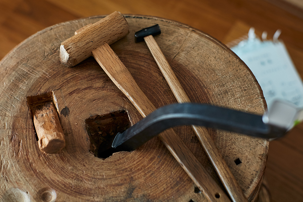 Hammer and tools to craft metal by hand.