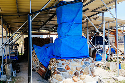 Keiji's kiln is covered before he starts to pack it with new work. The kiln will be fired for a week.