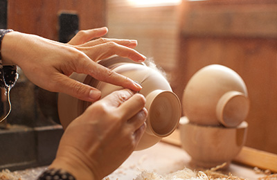 She then sands the bowl making the surface smooth and shiny, working out any small imperfections.