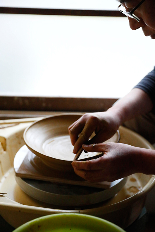 Makoto Asebi kneads the clay at his studio in Kamakura, Japan.