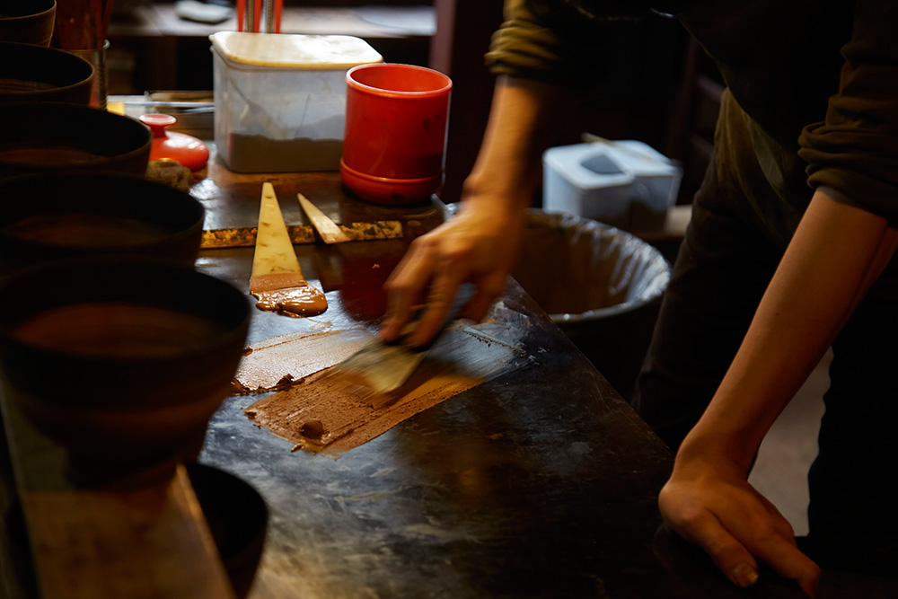 He mixes the lacquer to generate a new batch of urushi, this will be used to coat his works.