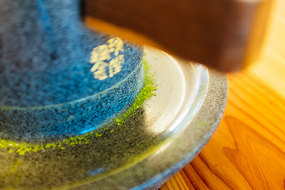 Matcha is made by grinding the tea leaves using a stone mill to create a fine green powder.