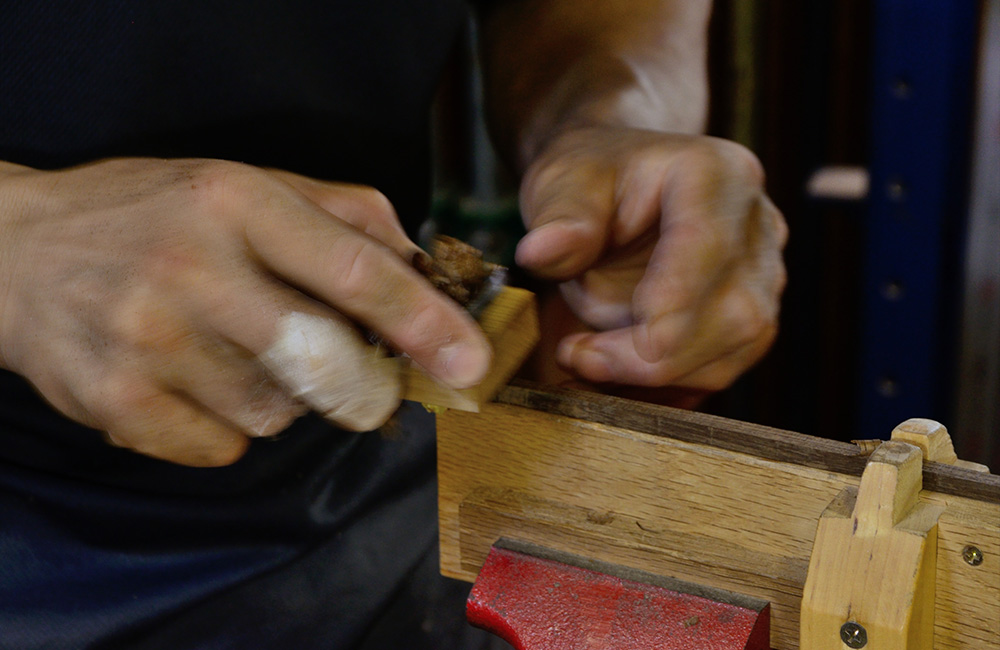 Perfecting the shape of the handle by hand, making sure the character of the wood will be showing in the final object.